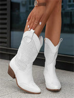 The Mary Stacy - Suede Western Ankle Boots with Perforation combine classic western style with contemporary flair.